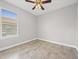 Bedroom with tile floors, a window with white blinds, and a ceiling fan at 1709 Benoit Ter, Davenport, FL 33837