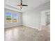 Bedroom featuring tile flooring, a ceiling fan, and bright views from two windows at 1709 Benoit Ter, Davenport, FL 33837