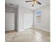 Bright bedroom featuring a ceiling fan, neutral walls, and light tile floors at 1709 Benoit Ter, Davenport, FL 33837
