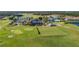 Aerial view featuring the golf course, clubhouse, and recreational facilities of the community at 1709 Benoit Ter, Davenport, FL 33837