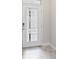 Modern front door with glass panels, tiled floor, and digital lock at 1709 Benoit Ter, Davenport, FL 33837
