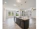 Stylish kitchen island with seating, stainless steel appliances, and ample counter space at 1709 Benoit Ter, Davenport, FL 33837