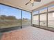 Enclosed lanai with brick flooring offers seamless transition between indoor and outdoor living spaces at 1709 Benoit Ter, Davenport, FL 33837