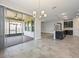 Open floor plan with sliding glass doors leading to the screened patio, and views of the kitchen and living room at 1709 Benoit Ter, Davenport, FL 33837