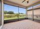 Screened patio offering outdoor space and views of the lawn and greenery at 1709 Benoit Ter, Davenport, FL 33837