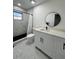Modern bathroom featuring a walk-in shower with sleek fixtures, a contemporary vanity, and elegant marble flooring at 1732 Sw 6Th St, Ocala, FL 34471