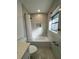 Bright and modern bathroom features a shower-tub combination and stylish fixtures at 1732 Sw 6Th St, Ocala, FL 34471