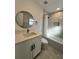 Modern bathroom with tub-shower, vanity, and decorative mirror at 1732 Sw 6Th St, Ocala, FL 34471