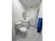 Bright bathroom featuring modern vanity, toilet, and round mirror, all complemented by stylish tile flooring at 1732 Sw 6Th St, Ocala, FL 34471