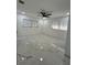 Bright bedroom featuring marble floors, a ceiling fan, and windows with decorative bars at 1732 Sw 6Th St, Ocala, FL 34471