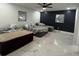 Spacious bedroom with three beds, featuring a ceiling fan and marble tile flooring throughout at 1732 Sw 6Th St, Ocala, FL 34471