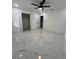 Spacious bedroom with marble floors, ceiling fan, and walk-in closet at 1732 Sw 6Th St, Ocala, FL 34471