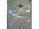 Well-lit bedroom with marble floors, ceiling fan, and dual windows at 1732 Sw 6Th St, Ocala, FL 34471
