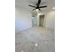 Bedroom with marble floors, ceiling fan, closet, and access to the bathroom at 1732 Sw 6Th St, Ocala, FL 34471