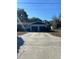 Exterior showcasing the two-car garage of the home with a long driveway under a clear blue sky at 1732 Sw 6Th St, Ocala, FL 34471