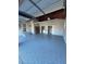 Spacious garage with freshly painted floors, featuring a side entry door and plenty of room for storage at 1732 Sw 6Th St, Ocala, FL 34471