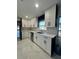 Well-lit kitchen featuring white cabinetry, subway tile, and modern stainless steel appliances at 1732 Sw 6Th St, Ocala, FL 34471