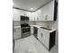 Bright kitchen featuring white cabinets, subway tile backsplash, stainless steel appliances, and modern finishes at 1732 Sw 6Th St, Ocala, FL 34471