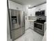 Modern kitchen featuring stainless steel appliances, white cabinetry, and a subway tile backsplash at 1732 Sw 6Th St, Ocala, FL 34471