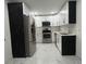 Updated kitchen with stainless steel appliances, marble floors, and white cabinetry at 1732 Sw 6Th St, Ocala, FL 34471