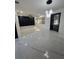 Well-lit living room with marble floors, modern light fixture, and fresh paint at 1732 Sw 6Th St, Ocala, FL 34471