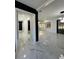Spacious living room with white marble floors and modern lighting, open floor plan at 1732 Sw 6Th St, Ocala, FL 34471