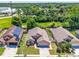 Aerial view of a well-maintained residential property with a manicured lawn and a paved driveway at 1803 Tillstream Dr, Orlando, FL 32818