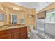 Bathroom showcasing a vanity with granite countertop and a glass-enclosed shower with a tile surround at 1803 Tillstream Dr, Orlando, FL 32818