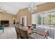 Bright dining area adjacent to the kitchen, featuring tile flooring, a modern chandelier, and sliding door access at 1803 Tillstream Dr, Orlando, FL 32818