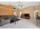Cozy living room with tile flooring, neutral walls, and a ceiling fan, perfect for relaxing and entertaining guests at 1803 Tillstream Dr, Orlando, FL 32818