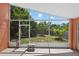 Enclosed patio with a large window, a table, a backyard view, and concrete flooring at 1803 Tillstream Dr, Orlando, FL 32818