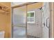 Shower featuring tile surround, glass doors, and a hand shower at 1803 Tillstream Dr, Orlando, FL 32818