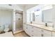 Bright bathroom features a double sink vanity, quartz countertop, and tiled walk-in shower at 1824 Dorris Dr, Orlando, FL 32807