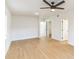 Bedroom featuring wood-look floors, white walls, and multiple doors and windows for an airy feel at 1824 Dorris Dr, Orlando, FL 32807
