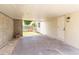 This carport features concrete floors, exterior lighting, and a door to the home's backyard at 1824 Dorris Dr, Orlando, FL 32807