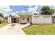 Charming single-story home with fresh exterior paint, a spacious carport, and inviting front yard landscaping at 1824 Dorris Dr, Orlando, FL 32807