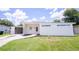 Inviting single-story home features modern exterior, well-maintained lawn, and convenient carport for parking at 1824 Dorris Dr, Orlando, FL 32807