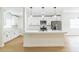 Beautiful kitchen features white cabinets, stainless steel appliances, granite countertops and a kitchen island with pendant lighting at 1824 Dorris Dr, Orlando, FL 32807