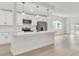 Bright kitchen features modern white cabinets, stainless steel appliances, and a large island for cooking and entertaining at 1824 Dorris Dr, Orlando, FL 32807