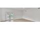 Bright living room with double doors leading to the backyard and wood-look floors at 1824 Dorris Dr, Orlando, FL 32807