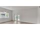 Bright living room with a large window and double doors leading to the backyard at 1824 Dorris Dr, Orlando, FL 32807