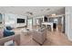 Bright living room featuring wood-look tile, modern furnishings, a ceiling fan, and an open floor plan at 1951 Betsy Ross Ln, St Cloud, FL 34769
