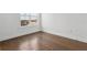Bright bedroom featuring hardwood floors and a window with neighborhood views at 2018 Packing District Way, Orlando, FL 32804