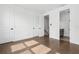 Spacious bedroom with hardwood floors, multiple doors, and easy access to an en-suite bathroom at 2018 Packing District Way, Orlando, FL 32804