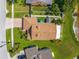 An aerial view showcases the property's layout, featuring a spacious backyard, proximity to the lake, and surrounding greenery at 2076 Shannon Lakes Blvd, Kissimmee, FL 34743