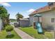View of the backyard, showcasing the well-maintained lawn, playground, and storage shed with a grill at 2076 Shannon Lakes Blvd, Kissimmee, FL 34743