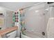 Bright bathroom features a shower-tub combo, and floral shower curtain at 2076 Shannon Lakes Blvd, Kissimmee, FL 34743