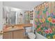 Charming bathroom with colorful shower curtain, vanity, and well-lit mirror at 2076 Shannon Lakes Blvd, Kissimmee, FL 34743