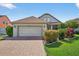Charming single-Gathering home with a brick driveway and well-maintained landscaping at 2076 Shannon Lakes Blvd, Kissimmee, FL 34743