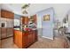 Kitchen view with island, stainless steel refrigerator and tiled floors at 2076 Shannon Lakes Blvd, Kissimmee, FL 34743